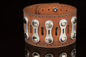 Image showing Brown leather bracelet isolated on a black