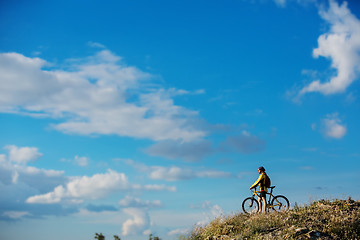 Image showing Young man cycling on a rural road