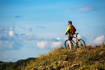 Image showing Young man cycling on a rural road