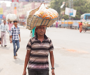 Image showing Man carrying flowers