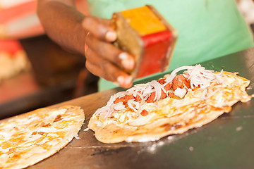 Image showing Street vendor preparing egg roll