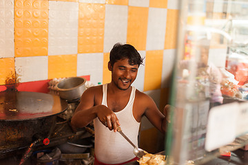 Image showing Street vendor preparing egg roll