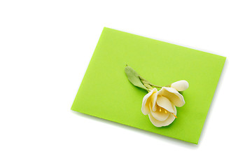 Image showing Close up of green envelope with flower