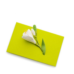 Image showing Close up of green envelope with flower