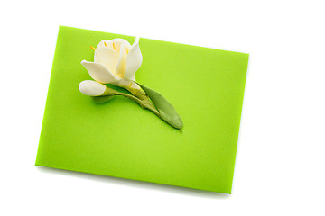 Image showing Close up of green envelope with flower