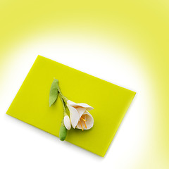 Image showing Close up of green envelope with flower