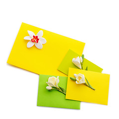 Image showing Close up of three yellow envelope with flowers