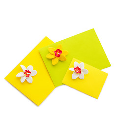 Image showing Close up of three yellow envelope with flowers