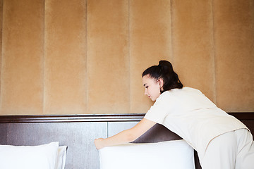 Image showing Hotel service. Made making bed in room.