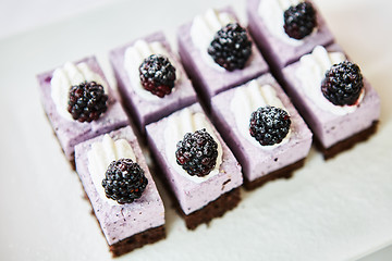 Image showing The rows of sweet and tasty cakes with blackberries.