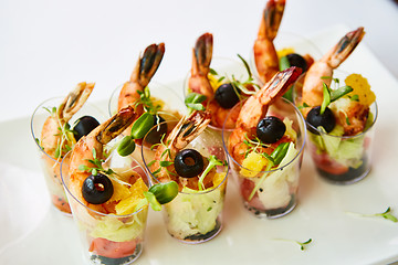 Image showing Shrimp, avocado, tomato, salmon cocktail salad served in a glass.