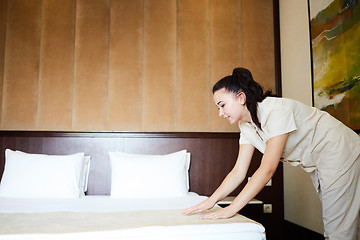 Image showing Hotel service. Made making bed in room.