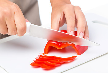 Image showing Cook is chopping bell pepper