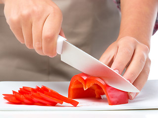 Image showing Cook is chopping bell pepper