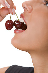 Image showing Biting into a cherry