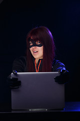 Image showing Young brunette hacker at night