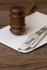 Image showing Wooden table with hammer, banknotes