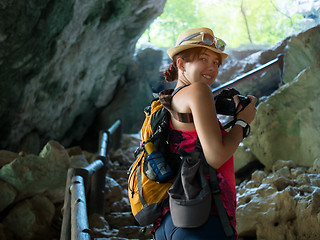 Image showing Girl with camera in cave