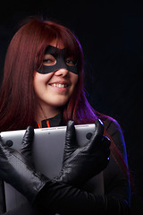 Image showing Beautiful thief in black gloves