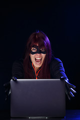 Image showing Screaming brunette hacker at night
