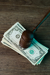 Image showing Judge\'s hammer lies on dollars