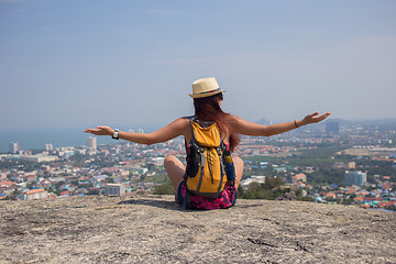 Image showing Woman sitting back on hill