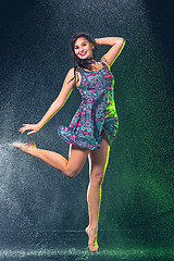 Image showing Young beautiful woman under splash of rain