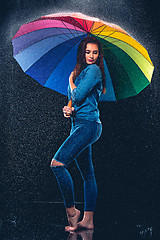 Image showing Young beautiful woman with an umbrella.