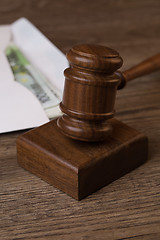 Image showing Wooden table with hammer, money