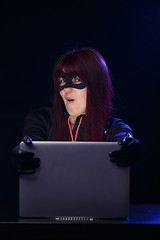 Image showing Young brunette hacker at night