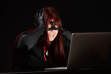 Image showing Happy hacker in black mask