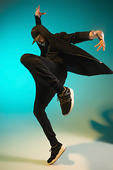 Image showing The silhouette of one hip hop male break dancer dancing on colorful background