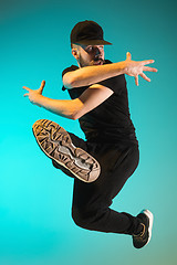 Image showing The silhouette of one hip hop male break dancer dancing on colorful background