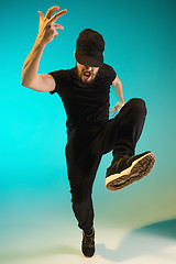 Image showing The silhouette of one hip hop male break dancer dancing on colorful background