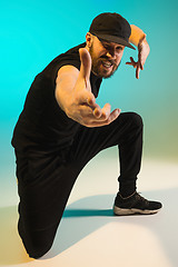 Image showing The silhouette of one hip hop male break dancer dancing on colorful background