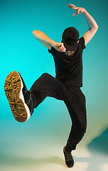 Image showing The silhouette of one hip hop male break dancer dancing on colorful background