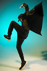 Image showing The silhouette of one hip hop male break dancer dancing on colorful background