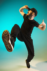 Image showing The silhouette of one hip hop male break dancer dancing on colorful background