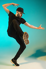 Image showing The silhouette of one hip hop male break dancer dancing on colorful background