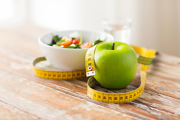 Image showing close up of green apple and measuring tape