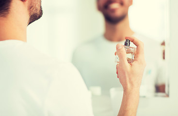 Image showing close up of man perfuming with perfume at bathroom