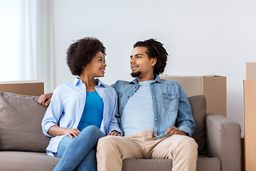 Image showing happy couple sitting on sofa and talking at home