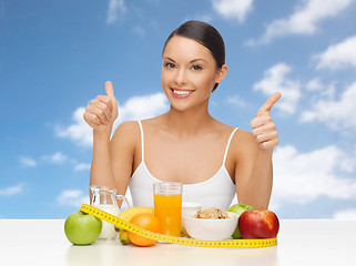 Image showing woman with fruits and vegetables showing thumbs up