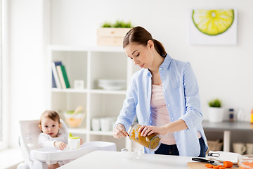 Image showing mother with blender cooking baby food at home