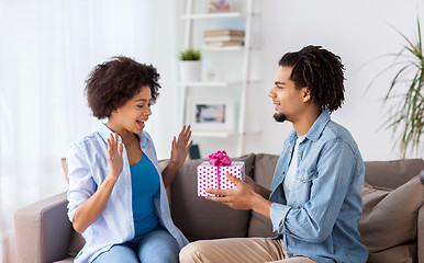 Image showing happy couple with gift box at home