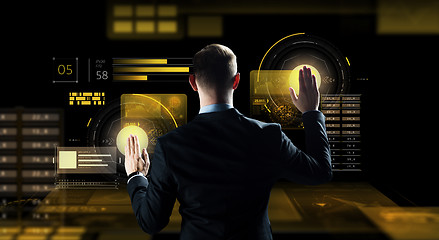 Image showing businessman touching virtual screen