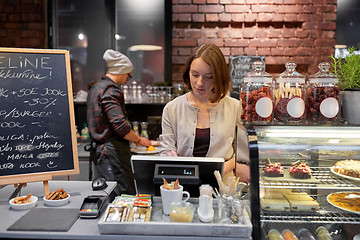 Image showing woman or barmaid with cashbox at cafe