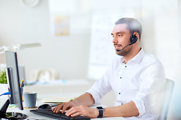 Image showing businessman with headset and computer at office