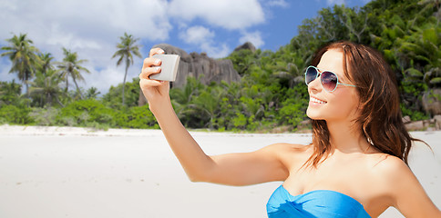 Image showing woman in swimsuit taking selfie with smatphone