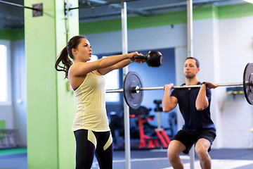 Image showing man and woman with weights exercising in gym